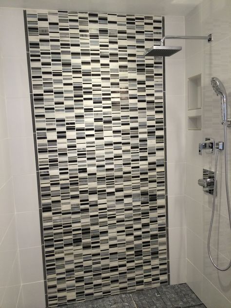 Our master shower.    White glossy porcelain 12 x 24 tile on the end walls.    Grey, black and white mosaic marble tiles on the back with grey pencil tile to separate.   The white porcelain tile wraps around.    Soap and shampoo niche with white tile.   Delta Argo faucets and shower head.    Adding a shower shield still. Shower Shield, Shampoo Niche, Pencil Tile, Black And White Mosaic, Mosaic Marble, White Porcelain Tile, Bathroom Upgrade, Master Shower, White Mosaic