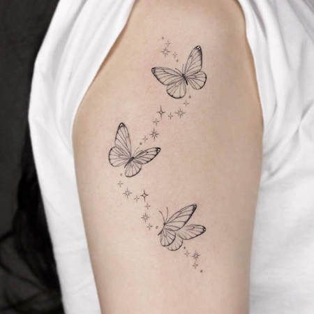 Butterfly Tattoo Meaning And The 100+ Most Beautiful Butterfly Tattoos You'll Love White Butterflies Tattoo, Butterflies On Vine Tattoo, Butterfly And Vine Tattoo Design, Stars And Butterfly Tattoos, Butterflies On Shoulder Tattoo, Delicate Butterfly Tattoo Designs, Butterfly Tattoo With Vines, Butterfly With Stars Tattoo, Butterfly And Sparkle Tattoo