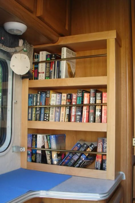 Camper Bookshelf, Rv Bookshelf Ideas, Trailer Bookshelf, Rv Book Storage, Diy Rv Bookshelf, Bookcase In Rv, Camper Bookstore, Camper Library, Rv Bookshelf