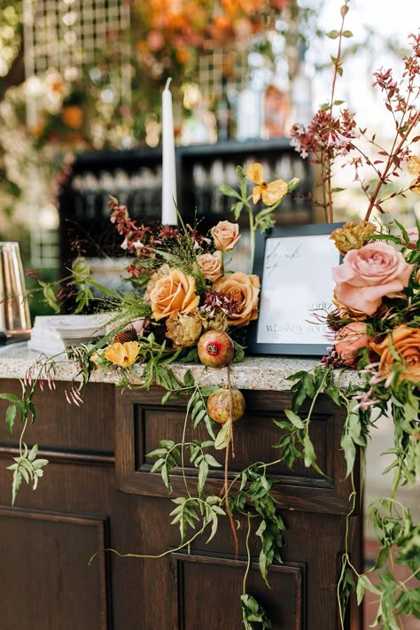 Dressed up bar menu encapsulated in an organic display of florals. Floral Mantle Wedding, Whimsical Greenery Wedding, Wedding Bar Flower Arrangement, Fall Floral Table Arrangements, L Shaped Flower Arrangement, Bar Floral Arrangement Wedding, Fall Florals Wedding, Bar Arrangement Wedding, Bar Flowers Wedding