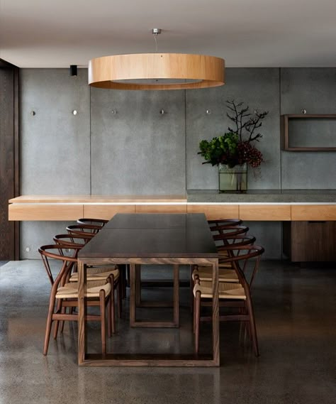 Modern Living Spaces // grey concrete floors pair well with a dark wood minimal table and classic chairs. The lighter wood and concrete counter tie it all together at this home in Hobart, Tasmania, designed by MGArchitects Large Farmhouse Table, Dining Room Decor Rustic, Farmhouse Dining Room Table, Dining Room Remodel, Modern Farmhouse Dining, Concrete Walls, Minimalist Dining Room, Dining Room Makeover, Interior Design Rustic