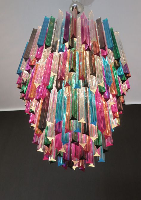 DUTIES AND SHIPMENTS COSTS INCLUDED IN THE FINAL PRICE Very Eclectic and beautiful Murano chandelier made with 187  multicolored crystal prism star shape with nickel metal frame.  The glasses are transparent, blue, smoky, purple, green, yellow and pink.  The glasses have two different sizes. This Chandelier has a strong personality but also very classy shape.  This piece will create a particular and beautiful atmosphere .  Dimensions: 66,90 inches height (170 cm) with chain;  37,40 inches height (95 cm) without chain;  23,60 inches diameter (60 cm)  Dimension glasses:  - 107 triedri: 11 inches (28 cm) height X 1,20 inches (3 cm) length  - 77 triedri: 13,80 inches (35 cm) height X 1,20 inches (3 cm) length   weight of chandelier 50 kg. Light bulbs: 12 lights bulbs: 1 E14 dimension + 11 E27 Multicolored Chandelier, Multicolor Chandelier, Funky Chandelier, 1stdibs Furniture, Color Chandelier, Cool Chandeliers, Metallic Interior, Colorful Chandelier, Colorful Lighting