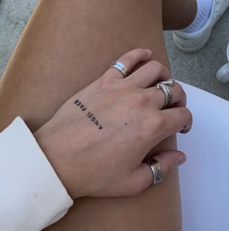 Hand Words Tattoo, Phrase Hand Tattoo, Word Angel Tattoo, Angel Tattoo Hand, Hand Text Tattoo, Hand Tattoo Writing, Angel Writing Tattoo, Writing On Hand Tattoo, Angel Tattoo Word