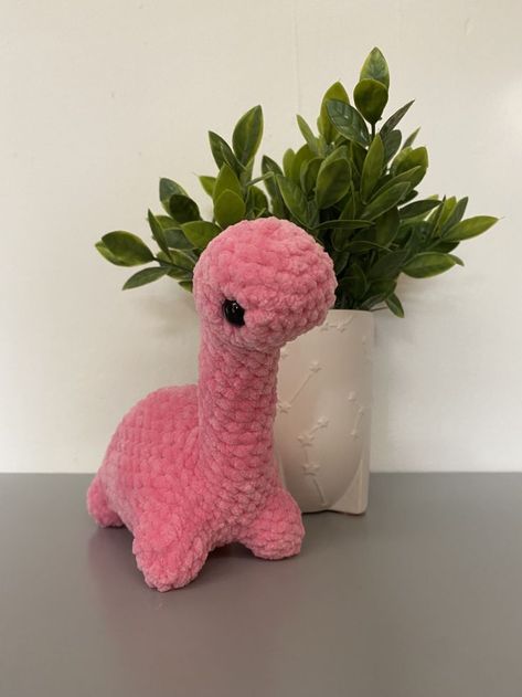 Crocheted pink brontosaurus! Crochet Animals Free Patterns Dinosaur, What To Crochet With Pink Yarn, Things To Crochet With Pink Yarn, Cute Pink Crochet, Pink Crochet Patterns, Crochet Pink Ideas, Pink Things To Crochet, Crochet Stuffies Free Pattern Easy, Pink Amigurumi Free Pattern