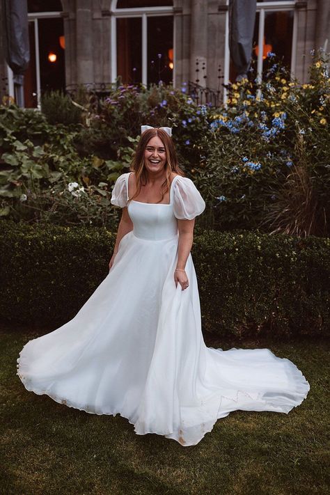 Real bride Sophie in Suzanne Neville Hailey wedding dress with custom sleeves for a Cowley Manor wedding. From Miss Bush bridal boutique Surrey. Worn with a satin hair bow by Gigi and Olive. Image © The Springles #missbush #suzanneneville #hailey #weddingdress #bridal #fashion #squareneck #corset #puffsleeves #hairbow #bow #bridalhair #accessories #styling High Neck Puff Sleeve Wedding Dress, Puffy Arm Wedding Dress, Puff Sleeve Satin Wedding Dress, Plus Size Puff Sleeve Wedding Dress, Square Neck Puff Sleeve Wedding Dress, Milkmaid Wedding Dress, Bubble Sleeve Wedding Dress, Bridgerton Style Wedding, Wedding Dress Puff Sleeves