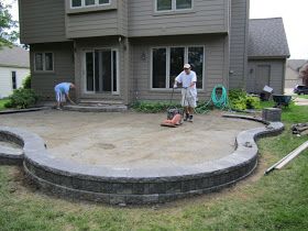 Patio Design Ideas: Installing A Paver Patio Elevated Paver Patio, Paver Patio On A Slope, Backyard Raised Patio Designs, Diy Raised Patio, Techno Block Patio, Elevated Patio Ideas, Steps Down To Patio, Raised Patio Ideas, Raised Paver Patio