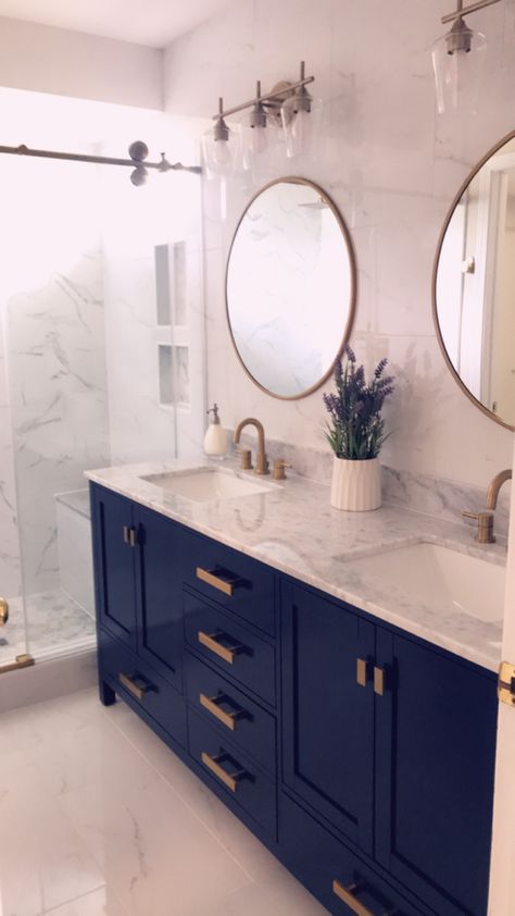 Valentino vanity blue and gold design with carrara marble top. Bathroom lights from wayfair. Faucets from floor and decor. Navy And Gold Ensuite, Navy Bathroom Vanity With Gold Hardware, Small Bathroom Remodel Blue Vanity, Colored Vanities Bathroom, Black Gold And Blue Bathroom, Navy Marble Bathroom, Blue Gold And Wood Bathroom, Coastal Bathroom Blue Vanity, Blue Marble Master Bath