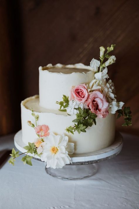 This wedding cake is decorated in pink spring florals like garden roses, dahlias and ivy. Small Spring Wedding Cake, Spring Garden Wedding Cake, Bridal Shower Cake Flowers, Bridal Shower Cake Floral, Love Is In Bloom Bridal Shower Cake, Small Floral Wedding Cake, Pastel Floral Wedding Cake, Love Is In Bloom Cake, Garden Party Wedding Cake