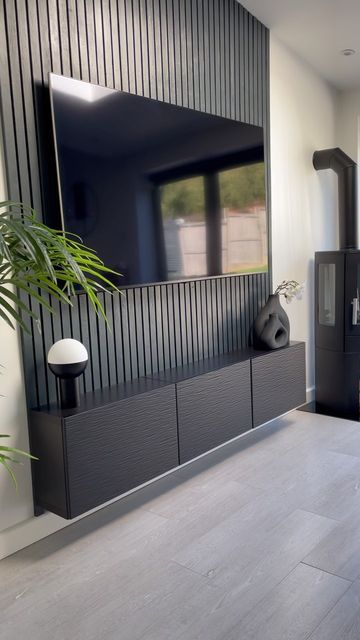 Matt Black Living Room, Black Wood Slat Tv Wall, Black Wood Media Wall, Black Wood Wall Paneling, Black Wood Tv Wall, Black Tv Wall Ideas, Black Statement Wall Living Room, Statement Living Room Wall, Black Panel Wall Living Rooms