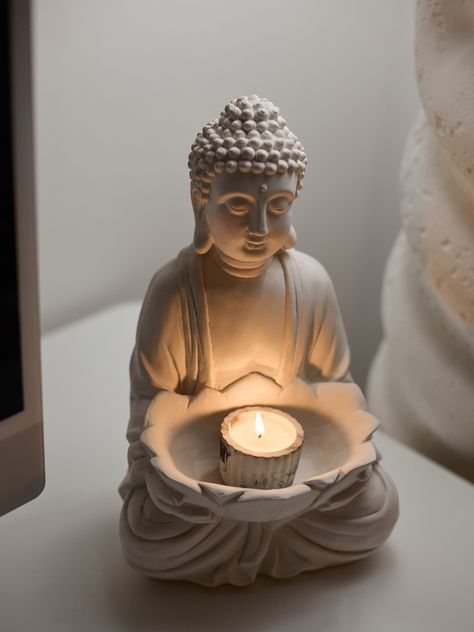 Buddha Candlestick: Sculptural Art Meets Versatility Introducing the unique Buddha Candlestick, where artistry meets practicality. This exquisite sculpture, inspired by the serene spirituality of Buddhism, not only harmonizes your interior but also doubles as a functional decor piece. Perfect as a serene candle holder, it embodies tranquility and enlightenment, transforming any space with its peaceful energy and aesthetic appeal. Unleash your creativity and personalize this piece by painting it in your favorite color! Make a statement and create a distinctive focal point in your environment with this versatile work of art. Dimensions: 7.5ʺW × 6ʺL × 13ʺH Handmade in Los Angeles Buddha Candle Holder, Buddha House Decor, Yoga Decor Zen Space, Spiritual Room Meditation Space, Buddha Aesthetic, Buddhism Aesthetic, Buddhist Home, Buddha Statue Decor, Home Yoga Room