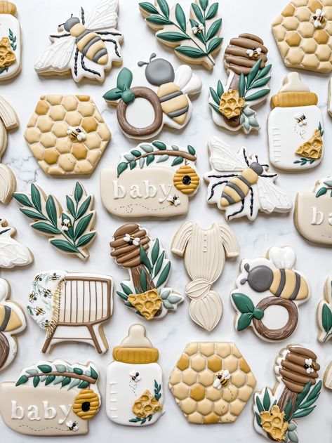 These golden yellow and soft neutral cookies are perfect for a bee themed baby shower. The greenery adds in a perfect pop. Add these to a gender reveal, gender neutral baby shower for a girl or boy, or even a first birthday. Royal Icing decorated sugar cookies by the Flour Shoppe Cookie Co Located in Omaha, Nebraska. Eclectic Baby Shower, Baby Shower Cookies Neutral, Bee Themed Gender Reveal, Gender Reveal Baby Shower Themes, Gender Reveal Cookies, Honey Bee Baby Shower, Bee Cookies, Storybook Baby Shower, Cookies Theme