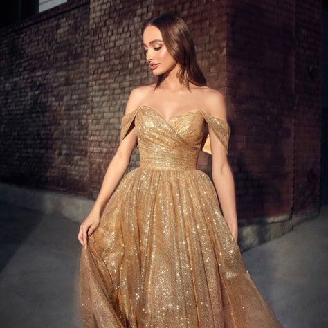 The Elegant Dress That Is Perfect For A Formal Event Is Made Of Delicate Glitter Tulle, Which Makes The Skirt Voluminous Creating A Light Image, While The Off Shoulder Neckline Will Complement The Image With Exquisite Jewelry. Fabric: Tulle Length: Tea Length Colour: Gold Neckline: Off Shoulder Silhouette: A-Line Sleeve: Sleeveless Back: Zipper Embellishments: Glitter Occasion: Romantic Date/Evening/Dinner, Wedding/Bridesmaid, Graduation, Fashion Show, Visiting Theater/Museum/Restaurant, Banquet Evening Dresses Elegant Off Shoulder, Cinderella Gold Dress, Gold Midi Dress Bridesmaid, Gold Off The Shoulder Prom Dress, Gold And Purple Wedding Dress, Gold Masquerade Dress, Gold Sparkle Prom Dress, Gold Dress With Sleeves, Glittery Bridesmaid Dresses