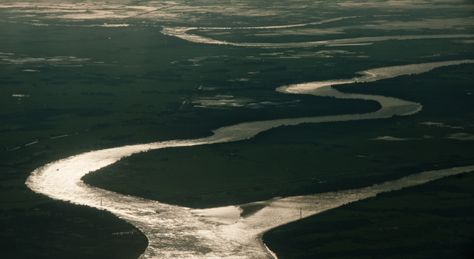 As the Irrawaddy River reaches the sea, it's valley flattens out into a broad delta. Irrawaddy River, Mandalay Myanmar, Rudyard Kipling, Unique Travel, Frozen In Time, Rural Landscape, Bagan, Mandalay, Travel Activities