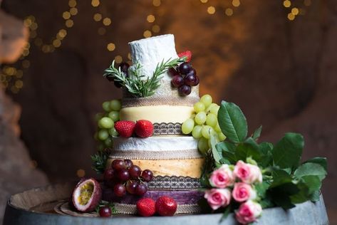 This incredible cheese wedding cake topped with brie, grapes, and fruit is one of our WeddingWire editors' top picks. WeddingWire has tons of unique cheese cake recommendations for all weddings. Click for more inspo for wedding cakes that match your unique wedding. Planning your wedding has never been so easy (or fun!)! WeddingWire has tons of wedding ideas, advice, wedding themes, inspiration, wedding photos and more. {Shawna Rae Wedding Photography} Wedding Cake October, Wedding Reception Cake, Canadian Dessert, Cheese Wedding, Cheese Wedding Cake, Reception Cake, Savory Dessert, Cake Tower, Wedding Cake Alternatives