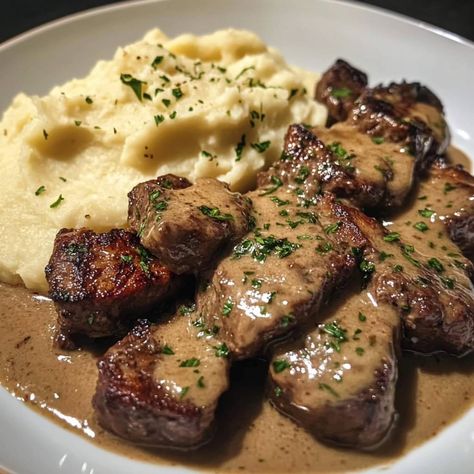 🧄🥩 Garlic Butter Steak Bites and Creamy Mash 🧄🥔 Ingredients For the Garlic Butter Steak Bites: 1 lb sirloin steak (or your preferred cut), cut into bite-sized cubes 🥩 Salt and pepper to taste 🧂 2 tbsp olive oil 🫒 4 tbsp butter 🧈 5 cloves garlic, minced 🧄 1 tsp dried thyme 🌿 1 tsp dried rosemary 🌿 Fresh parsley, chopped (for garnish) 🌱 For the Creamy Mash: 4 large russet potatoes, peeled and cubed 🥔 1/2 cup heavy cream 🥛 1/4 cup butter 🧈 Salt and pepper to taste 🧂 1/4 cup grated Parmesan chees... Garlic Pepper Steak, Food With Beef, Garlic Butter Steak Bites, Butter Steak Bites, Dried Rosemary, Butter Steak, Minced Beef, Creamy Mash, Sirloin Steak