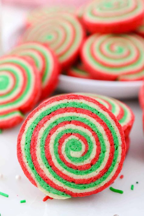 These festive and easy Christmas Pinwheel Cookies are dyed vibrant red and green and instantly brighten up a holiday cookie platter! Christmas Pinwheel Cookies, Pinwheel Sugar Cookies, Rainbow Sugar Cookies, Best Christmas Cookie Recipes, Drop Sugar Cookies, Cookie Recipes Decorating, Traditional Christmas Cookies, Cookie Cups Recipe, Christmas Cookie Recipe