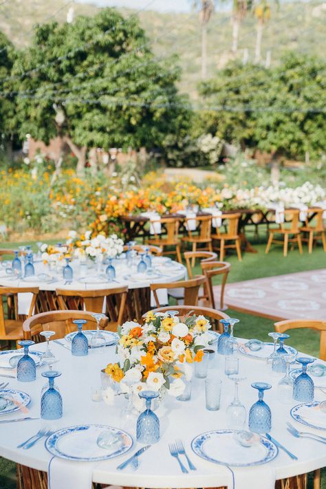 A custom jean jacket for the bride, lush pop of orange florals, a chic something blue wedding design, and dreamy views of the Mexican countryside came together perfectly for Maggie & Jeremy's I-DOs at Flora Farms in San Jose Del Cabo. We love how Amy Abbott Weddings & Events, Gideon Photography, and Pina Hernandez brought the day together. August Themed Wedding, Gold Green Blue Wedding, Spaniard Wedding Theme, Blue Yellow And Orange Wedding, Light Yellow And Light Blue Wedding, Yellow And Blue Themed Wedding, Blue Coastal Wedding Theme, Blue And Orange Wedding Decor, Yellow Aesthetic Wedding