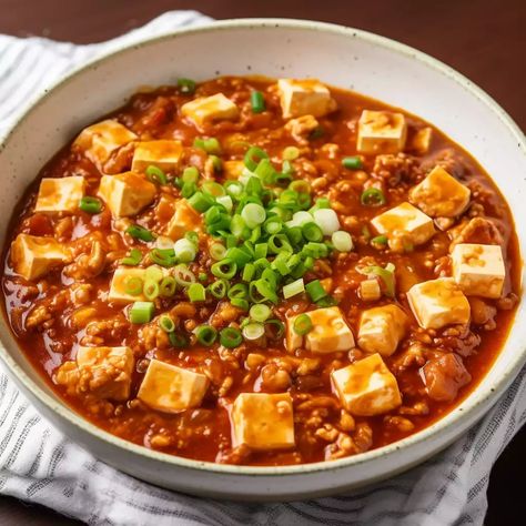 Mapo Tofu, an iconic recipe originating from the Sichuan province of China, has been tantalizing palates for generations. Known for its rich, spicy, and savoury flavours, this dish is a staple in Chinese cuisine and has made a mark in kitchens worldwide.  The history of Mapo Tofu dates back to the Qing Dynasty. Legend has […] The post Mapo Tofu appeared first on Scrumptiously. Spicy Mapo Tofu, Tofu Spicy, Tofu Food, Mapo Tofu Recipe, Sichuan Province, Food Chinese, Food Pic, Mapo Tofu, Hot And Sour Soup