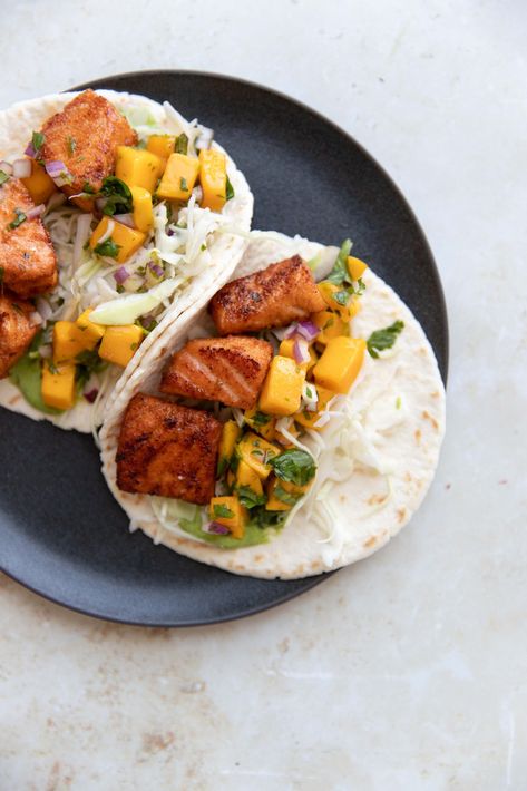 These salmon tacos with fresh mango salsa are the perfect quick meal. Flavorful salmon is paired with fresh salsa and a cilantro lime sauce. Mango Tacos, The Palatable Life, Palatable Life, Yogurt Dill Sauce, Tacos With Mango Salsa, Mango Salsa Salmon, Fresh Mango Salsa, Perfect Grilled Cheese, Harissa Chicken