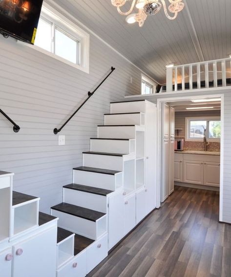 The interior matches the exterior with its light gray walls and white trim. A double storage staircase leads up to the two king-size bedroom lofts. Tiny House Stairs Storage, Double Stairs, Stairs Floor Plan, Tiny House Building, Apartemen Studio, Storage Stairs, Tiny House Stairs, Tiny House Interior Design, Tiny House Loft