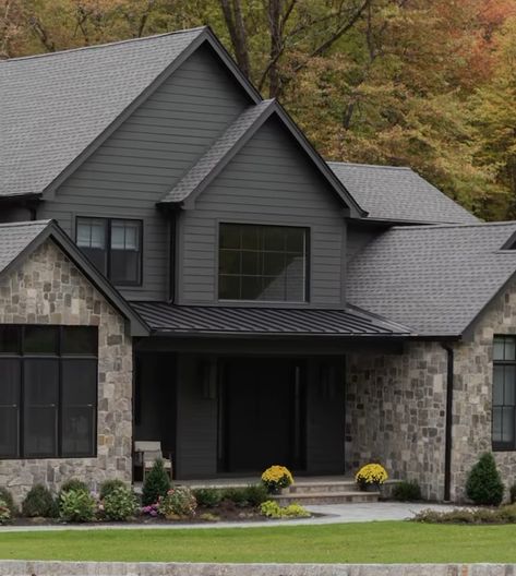 Dark Exterior With Stone, House Exterior Dark Grey, Dark Gray Ranch House Exterior, Dark Grey Farmhouse Exterior, Dark House Colors, Charcoal House Exterior, Urban Bronze Exterior House, Dark Grey House Exterior, Grey Farmhouse Exterior