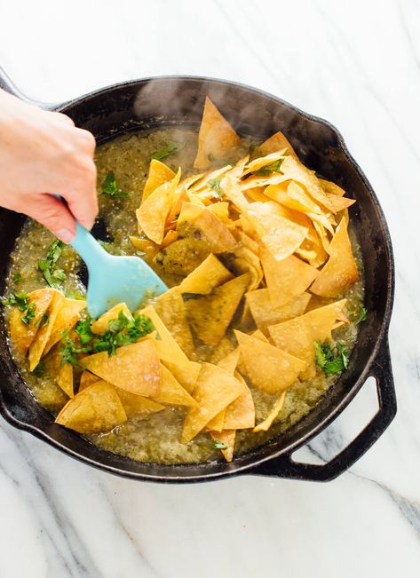 How to make chilaquiles verdes (tortilla chips tossed in warmed salsa verde, often served with fried eggs on top) - cookieandkate.com Recipes With Tortilla Chips, Chillaquilles Recipe, Chilaquiles Verdes Recipe, How To Make Chilaquiles, Chilaquiles Recipe, Baked Tortilla Chips, Verde Recipe, Mexican Breakfast Recipes, Tortilla Recipe