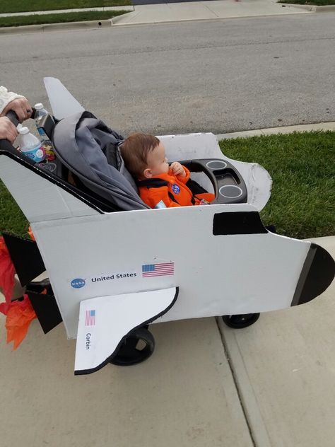 DIY space shuttle stroller Halloween costume-astronaut Spaceship Stroller Costume, Stroller Rocket Ship, Rocket Stroller Costume, Stroller Rocket Ship Costume, Costumes With Strollers, Halloween Stroller Costumes, Halloween Costumes With Stroller, Halloween Stroller Ideas, Astronaut Family Costume