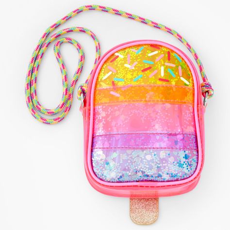 This tasty crossbody with a trendy shaker design is a Summer wardrobe staple. Zippered closure and rope-style crossbody strap gives function to an eclectic piece. Pair this popsicle-shaped bag with your summer 'fit. Get melty! Crossbody Bag by Claire's Club Dimensions: 5" W x 6.5'' H Closure: Zipper Material: PVC/Vinyl Suitable for ages 3-6 - Claire's Club Rainbow Popsicle Transparent Shaker Crossbody Bag Barbie Party Decorations, Makeup Kit For Kids, Summer Wardrobe Staples, Rainbow Bag, Pop Bubble, Kids' Bag, Barbie Party, Fashionable Jewelry, Pvc Vinyl