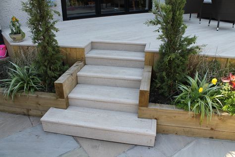 Raised deck Millboard terrace with steps leading down to a sun terrace. Raised Garden Terrace, Raised Patio Garden Ideas, Raised Terrace Patio, Patio With Steps Up To Garden, Raised Garden Patio, Step Down Garden, Raised Patio With Steps, Decking With Steps, Decking Steps Down To Garden