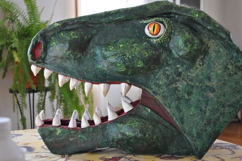 T-Rex head, paper mache. 2014 Paper Mache Dinosaur Head, Dinosaur Vbs, Cardboard Masks, Dinosaur Wedding, Dinosaur Birthday Decorations, Make A Dinosaur, Scarecrow Ideas, Jurassic Park Birthday, Cardboard Mask