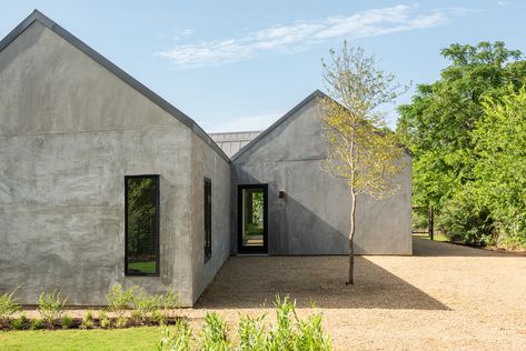 Exterior walls are sheathed in stucco with a hard-troweled finish that looks similar to concrete. Stucco Siding, Lake Flato, Stucco Walls, Hacienda Style, Exposed Concrete, New West, Higher Design, Indoor Outdoor Living, Modern Homes