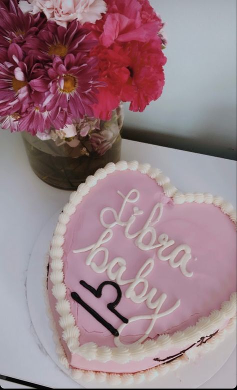 A picture of a pink heart shaped cake that says Libra baby in icing and a bouquet of pink flowers in the background of picture Birthday Cake Libra Zodiac, Libra Season Cake, Libra Szn Cake, Libra Baby Cake, Libra Cake Ideas, Libra Birthday Cake, Libra Princess, Libra Cake, Art Birthday Cake