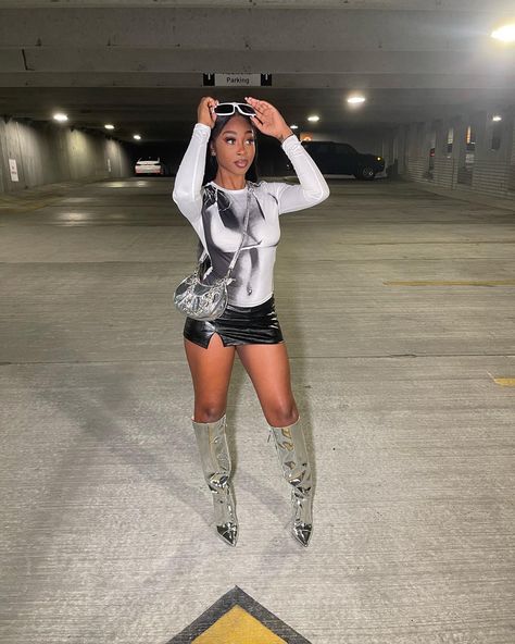 Chrome Boots Outfit Ideas, Metallic Baddie Outfit, Mini Skirt And Knee High Boots Outfit, Silver Knee Boots Outfit, Silver Boot Outfit Ideas, Metalic Heel Outfit, Black Mini Skirt Outfit Baddie, Outfits With Leather Mini Skirt, Leather Skirt Outfit Boots