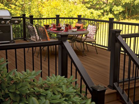 Paint the trellis dark???  decking in Tudor Brown with Mission rail in black and metal balusters Dark Deck, Metal Balusters, Deck Railing Design, Black Deck, Deck Colors, Storage Inspiration, Deck Paint, Staining Deck, House Deck