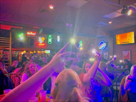 People holding up lights in a bar in support of karaoke College Bar Aesthetic, Bar Aesthetic, Perry County, 80s Rock, Back 2 School, College Town, Halloween 2023, 2024 Vision, College Life