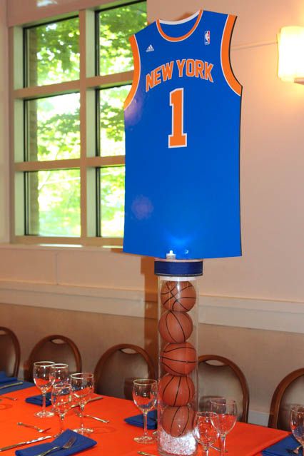 Basketball Jersey on Vase with Basketballs Centerpiece Sports Themed Centerpieces, Basketball Centerpieces, Candy Bar Comunion, Basketball Table, Athletic Banquet, Basketball Bar Mitzvah, Sports Centerpieces, Bar Mitzvah Centerpieces, Basketball Party Ideas