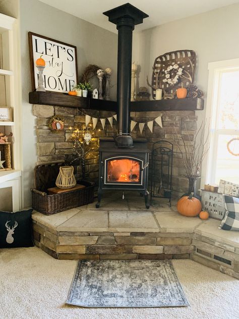 #woodstove #homedecor #cornermantle #farmhouse #fall #falldecor #mountains Raised Woodstoves, Woodstove Mantle Decor, Wood Stove Area Ideas, Wood Burning Stove Corner Farmhouse, River Rock Wood Stove Surround, Pellet Stove Hearth Ideas, Wood Stove Mantle, Wood Burning Stove Living Room, Woodstove Mantle