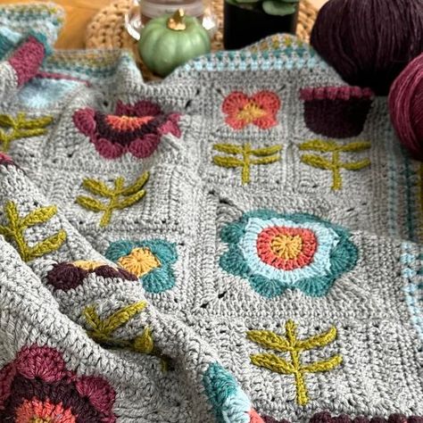 Anita Gibney on Instagram: "The choice of yarn can make a huge difference to the appearance of a project! Swipe to see how my Scandi Meadow pattern changes completely in different yarns.   If you would like to known more about the Scandi Meadow pattern, comment ‘yes’ below and I will send you the links to the pattern and blog posts about the yarns I used. 🌸🌼🌷  #crochetinspiration #blanketmaker #crochetdesigner  #crochetblanket #madebyanita #crochetlove #instacrochet #crochetdesigner #crochet #grannystripes #grannysquares" Folk Art Crochet, Scandinavian Crochet Blanket, Adult Blankets, Textile Inspiration, Adult Blanket, Crochet Afghans, The Choice, Crochet Blankets, Crochet Blanket Patterns