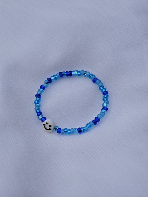 Winter Seed Bead Bracelet This bracelet is made with stretchy string, blue seed beads and a smiley face char, Seed Bead Bracelet, Seed Bead Bracelets, Smiley Face, Bead Bracelet, Seed Bead, Smiley, Seed Beads, Jewelry Bracelets, Seeds