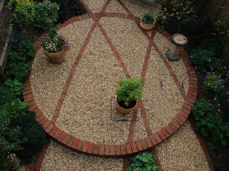 ariel shot of a simple design for a small garden, featuring a brick circle and detailing Circular Gravel Garden, Circular Pavers Design, Circle Pavers Ideas, Brick And Gravel Patio, Brick Circle Patio, Garden Circle Ideas, Circular Brick Patio, Brick Circle, Rock Pathways