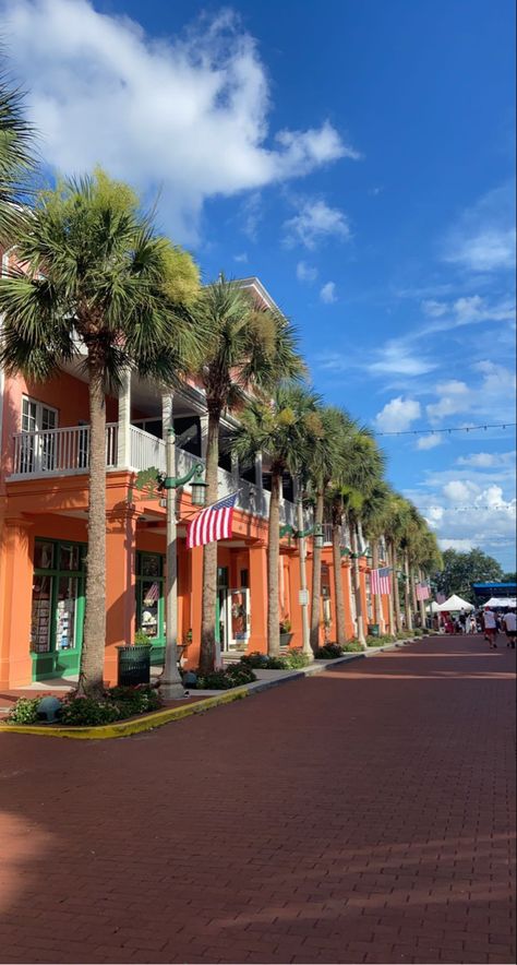 stunning orange buildings with green doors, white balconies and big palm trees, american flag hanging down and clear blue skies Celebration Orlando, 4th Of July Celebration, Beautiful Streets, Little Twin Stars, Orlando Florida, Orlando, 4th Of July, Florida, House Styles