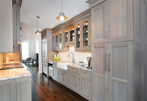 Galley style kitchen in a gray washed wood stain Light Grey Stained Kitchen Cabinets, Grey Wash Kitchen Cabinets, Wash Kitchen Cabinets, Gray Stained Kitchen Cabinets, Grey Stained Kitchen Cabinets, Gray Stained Cabinets, Greige Kitchen, Hickory Kitchen, Stained Kitchen Cabinets