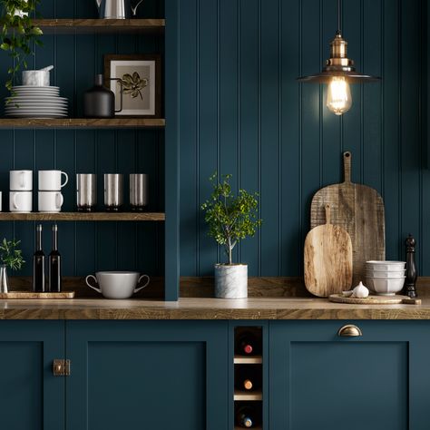 In need of blue kitchen inspiration or shaker kitchen inspiration? Our Chilcomb Paintable Marine Blue Kitchen is perfect for your blue kitchen ideas and traditional kitchen ideas. The solid oak worktop, wall panelling and aged brass hardware are perfect for creating a traditional kitchen design. Add your favourite home decor, shelving ideas and integrated wine rack to create a rustic kitchen design. We love this image for kitchen decor ideas and kitchen styling ideas. Kitchen Navy Walls, Vintage Blue Kitchen Cabinets, Navy Blue And Wood Kitchen, Muted Blue Kitchen, Navy Traditional Kitchen, Deep Blue Kitchen Cabinets, Traditional Blue Kitchen, Rustic Blue Interior, Rustic Shaker Kitchen