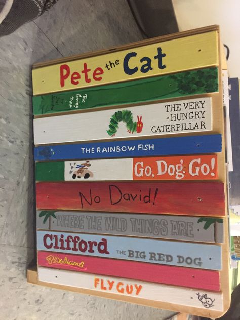 Side of bookcase for my classroom. Hand painted to look like children's book spines. Classroom Bookcase Ideas, Story Book Theme Classroom, Read Sign For Classroom Diy, Painted Book Spines, Book Spine Painting, Spine Painting, Book Mural, Library Murals, Brick Books