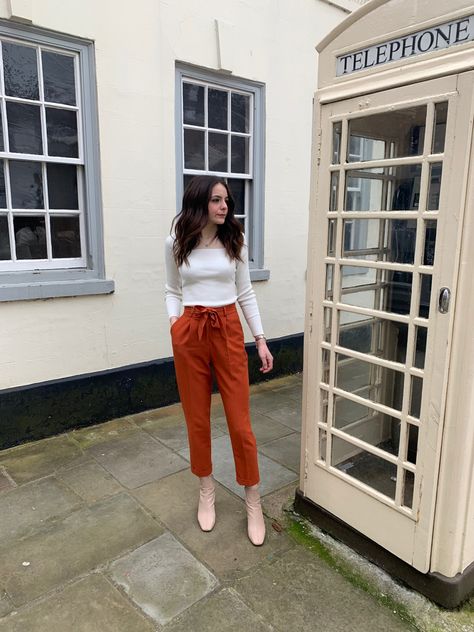 Orange pants white top nude boots Orange Paper Bag Pants Outfit, Bag Pants Outfit, Paper Bag Pants Outfit, Orange Trousers, Paper Bag Trousers, Plain White Top, Paper Bag Pants, Nude Boots, Bag Pants