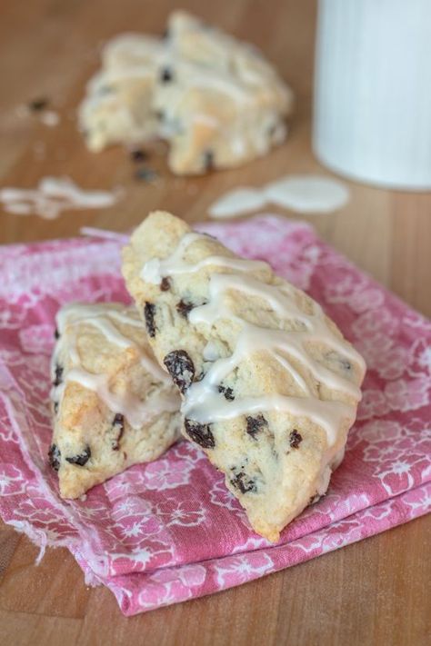 Tender and rich with nuggets of fruity flavor, these Raisin Scones are a quick and easy treat. With a drizzle of vanilla glaze for sweetness, they’re a perfect  accompaniment to a hot mug of coffee or tea. #breakfast #brunch #scones #raisinscones #recipes #sweets #coffeebreak #raisins #teatime Brunch Scones, Chocolate Peanut Butter Muffins, Raisin Scones, Raspberry Scones, Tea Breakfast, Peanut Butter Muffins, Mug Of Coffee, Easy Treat, Vanilla Glaze