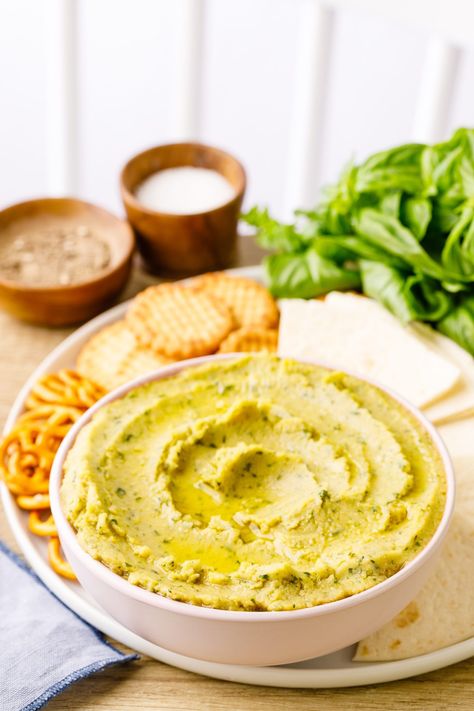 Basil Pesto Hummus - Nurtured Homes Basil Pesto Hummus, Basil Hummus, Classic Hummus, Pesto Hummus, Tomato Basil Chicken, Hummus Ingredients, Flavored Olive Oil, Jalapeno Recipes, Basil Recipes