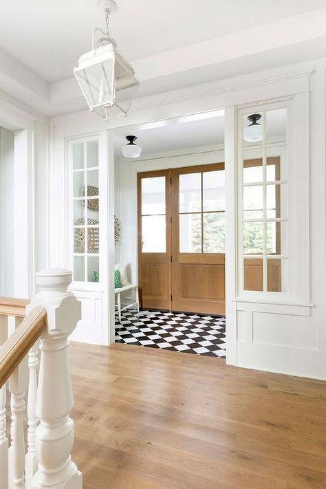 Cottage vestibule designed with black and white harlequin floor tiles, wood doors with glass panels, and schoolhouse semi flush mount lights. Dröm Hus Planer, Entryway Flooring, Entrance Foyer, Foyer Design, Flex Room, Design Del Prodotto, Design Case, House Inspo, Home Staging