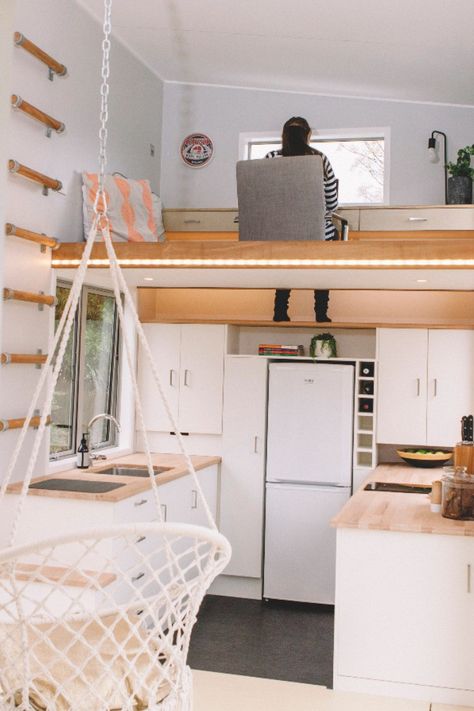 A wall ladder provides access to an office loft with built-in desk attached to the wall. A foot-well drops down to a shelf in the kitchen below to allow you to sit comfortably on the floor. Loft Stairs Ideas, Design Casa Piccola, Tiny Home Office, Tiny Loft, Tiny House Interior Design, Tiny House Builders, Tiny House Loft, House Loft, Tiny House Inspiration