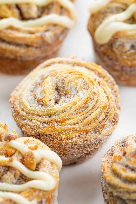 Absolutely delicious Carrot Cake Cruffins are crescent roll dough rolled up with all of the flavors of carrot cake, from the spices to the carrots to candied walnuts. The cruffins are rolled, cut, and baked in a muffin tin before being coated in more sugar and drizzled with a cream cheese glaze. It's the next best (and unique) way to enjoy all the flavors of a carrot cake! Carrot Cake Croissant, Unique Muffins, Unique Muffin Recipes, Crescent Roll Carrots, Cruffin Recipe, Mini Carrots, Carrot Cake Muffins, I Am Baker, Breakfast Sweets